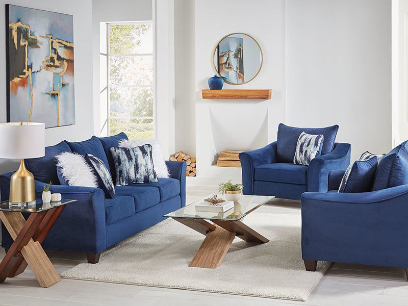 Image of blue sofa, chair and loveseat with gold accents in the room